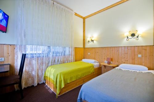 Säng eller sängar i ett rum på Hotel Polina