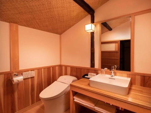 a bathroom with a toilet and a sink at Kanade Matsubaragokomachi-Momijittei in Kyoto