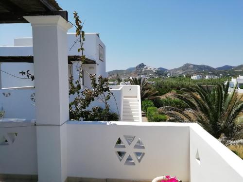 a white house with a view of the mountains at Vina Beach Hotel in Skiros
