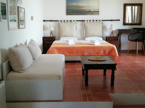 a living room with two beds and a couch at Vina Beach Hotel in Skiros