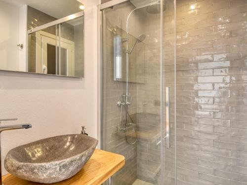 a bathroom with a stone sink and a shower at Refurbished apartment calella de pal. beach 250mts in Calella de Palafrugell