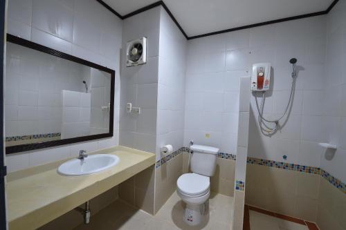 a bathroom with a sink and a toilet and a mirror at AT TP HOTEL in Phetchabun