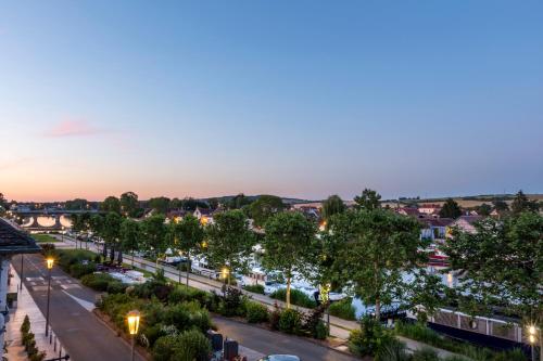 a view of a city street at dusk at Hôtel Le Maxime - Best Western Signature Collection in Auxerre