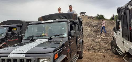 two men standing on top of a military truck at Nature Night Homestay in Sigiriya