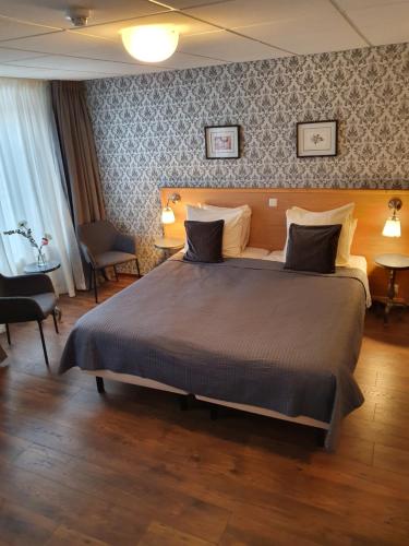 a bedroom with a large bed in a room at City Hotel Meppel in Meppel