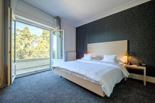 Postel nebo postele na pokoji v ubytování Hotel Mon Repos