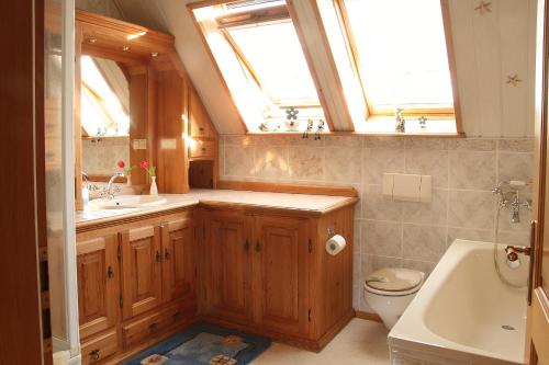 La salle de bains est pourvue d'un lavabo, de toilettes et d'une fenêtre. dans l'établissement Ferienwohnungen im Altbauernhaus, à Hohendorf