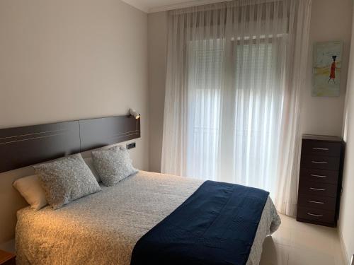 Llit o llits en una habitació de Apartamentos Illa