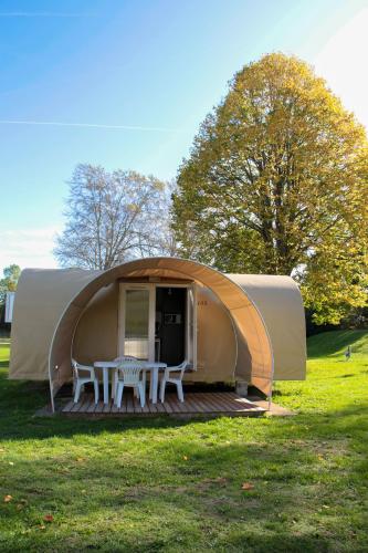 a dome tent with a table and chairs in a field at Camping Au Coeur de Vendome in Vendôme