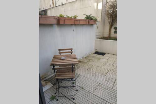 a wooden bench sitting on a sidewalk next to a building at Diva Alojamento in Matosinhos