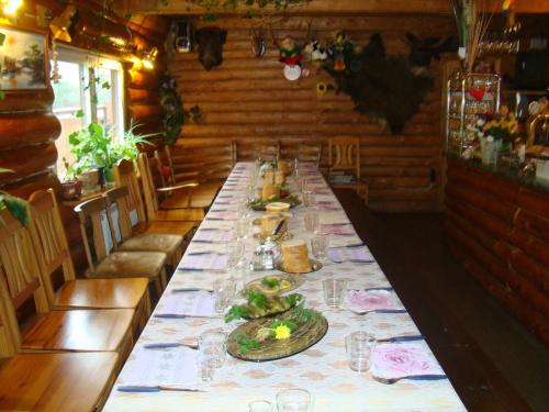a long table with plates of food on it at Tera in Saulkrasti