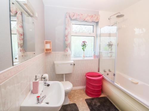 a bathroom with a sink and a toilet and a window at Upper Haven in Eyeries