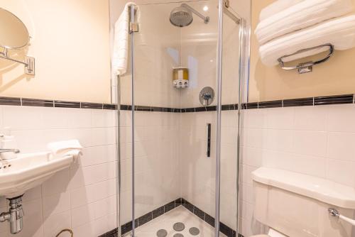 a bathroom with a shower and a sink and a toilet at Newly Converted Apartment Rowntree House Shambles in York