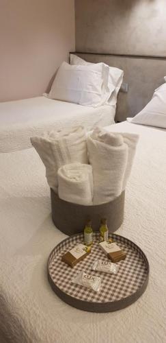a tray of towels sitting on top of a bed at Affittacamere Joss in La Spezia