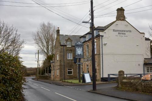 an old building with a clock on the side of a street at Ravensworth Arms by Chef & Brewer Collection in Gateshead
