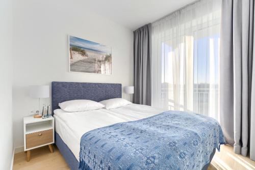 Ένα ή περισσότερα κρεβάτια σε δωμάτιο στο Apartamenty Marina z widokiem na morze
