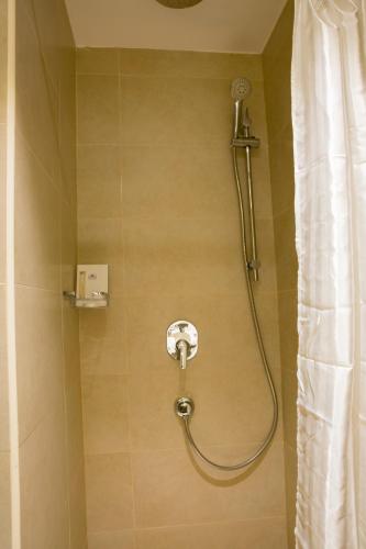 a shower in a bathroom with a shower curtain at Hibatullah Hotel Makkah in Makkah