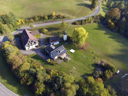an aerial view of a large house in a field at Ferienwohnungen Schwabenhof in Schramberg
