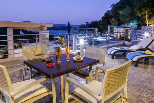 a table and chairs on a patio with a view at Thealos Village in Lygia