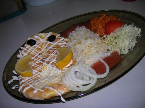 a plate of food with a sandwich and rice at Tera in Saulkrasti