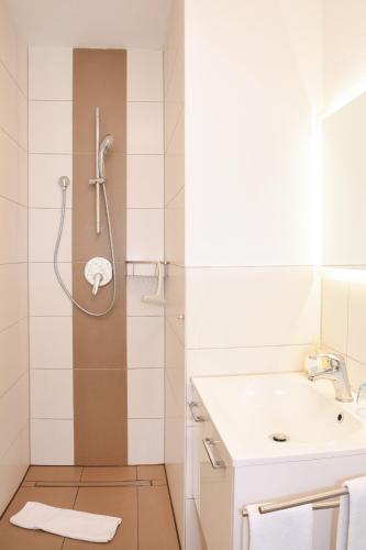 a bathroom with a shower and a sink at Pension Freiheit in Pfronten