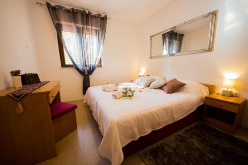 a bedroom with a large bed with flowers on it at Villa Novak in Čilipi