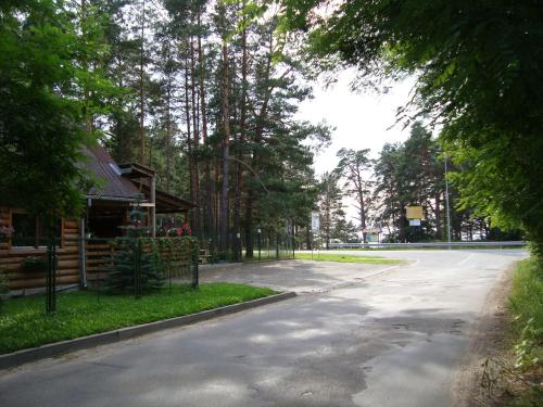 an empty road next to a building and trees at Tera in Saulkrasti