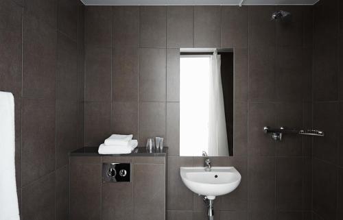 a bathroom with a sink and a mirror at The Social Hub Rotterdam in Rotterdam