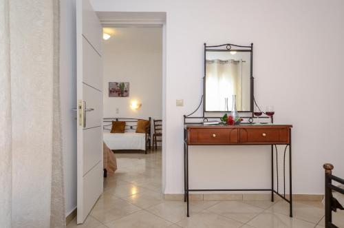 a bathroom with a vanity and a mirror on a wall at Gaitani apartments plaka naxos in Mikri Vigla