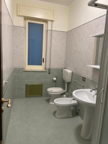 a bathroom with two toilets and a sink at Casa Olivella in Santa Flavia