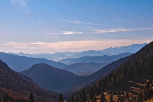 a view of a valley with mountains in the distance at Cimon Dolomites Hotel in Predazzo