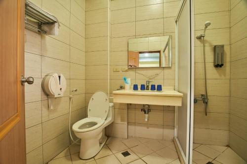 a bathroom with a toilet and a sink and a shower at City-Corner in Wujie