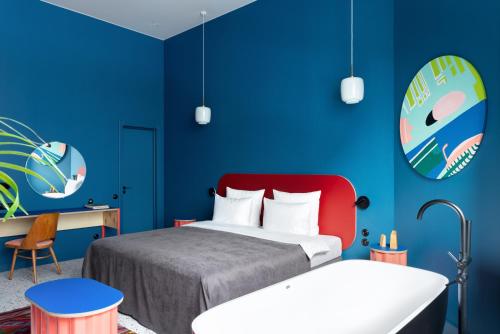 a bedroom with a bed and a blue wall at P17 Hotel in Moscow