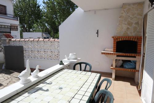 a patio with a table and a fireplace at Orlina in Empuriabrava