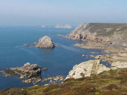 an island in a body of water with rocks at LE PETIT NID DANS LA ROULOTTE in Roscanvel
