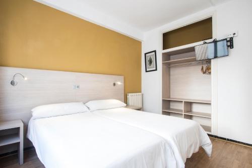 a bedroom with a large white bed and a window at Hotel Benidorm City Olympia in Benidorm