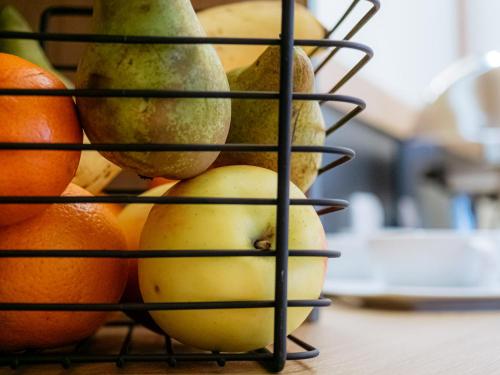 a black wire rack with fruit on top of a table at Rezydencja Markowy Dworek in Białka Tatrzanska