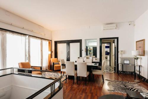 a living room with a table and a dining room at Casa Vilaró Park Guell in Barcelona