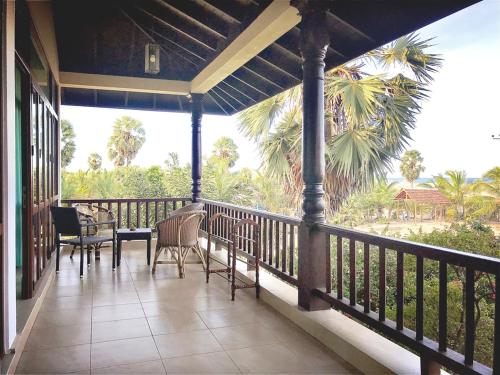 
a patio area with a patio table and chairs at Dream Garden in Arugam Bay

