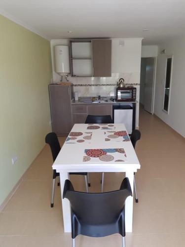 a kitchen with a white table and chairs in a room at CENTRO RENT APART in Federación