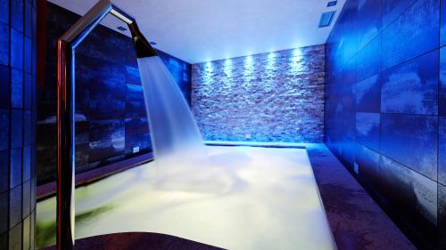 a staircase in a room with blue lights at Hotel La Maison Wellness & Spa in Alleghe
