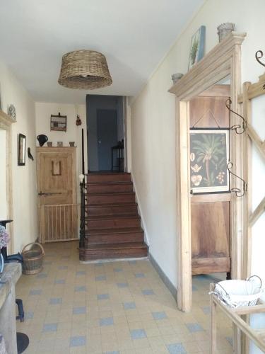 a room with a staircase and a stair case at Meublé de tourisme La Maison d'Orgy in Chevannes