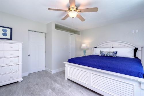 a bedroom with a bed and a dresser at Matecumbe Resort in Islamorada