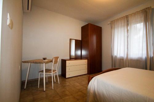 a bedroom with a bed and a desk and a table at AceroRosso B&B in Salerno