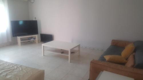 a living room with a couch and a table at Kololi 2 Bed room Apartment in Kololi