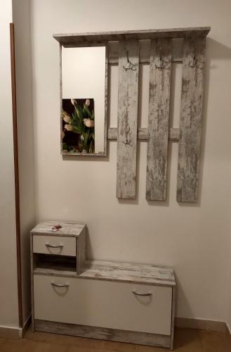 a room with a bench and a picture on the wall at Appartamenti Pedrini in Comano Terme