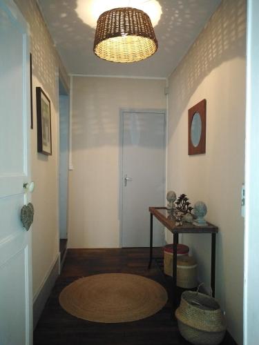 a hallway with a door and a round rug at Meublé de tourisme La Maison d'Orgy in Chevannes