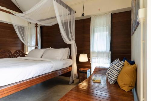 a bedroom with a bed with a canopy at Baan Boon in Bangkok