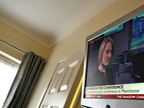 a television screen with a picture of a woman at Hotel Belmonte in Norwich