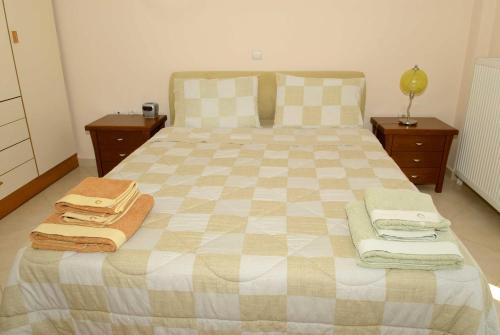 a bedroom with a large bed with towels on it at Luxury villa with a swimming pool in Lefkochoara, Messinias in Levkokhóra